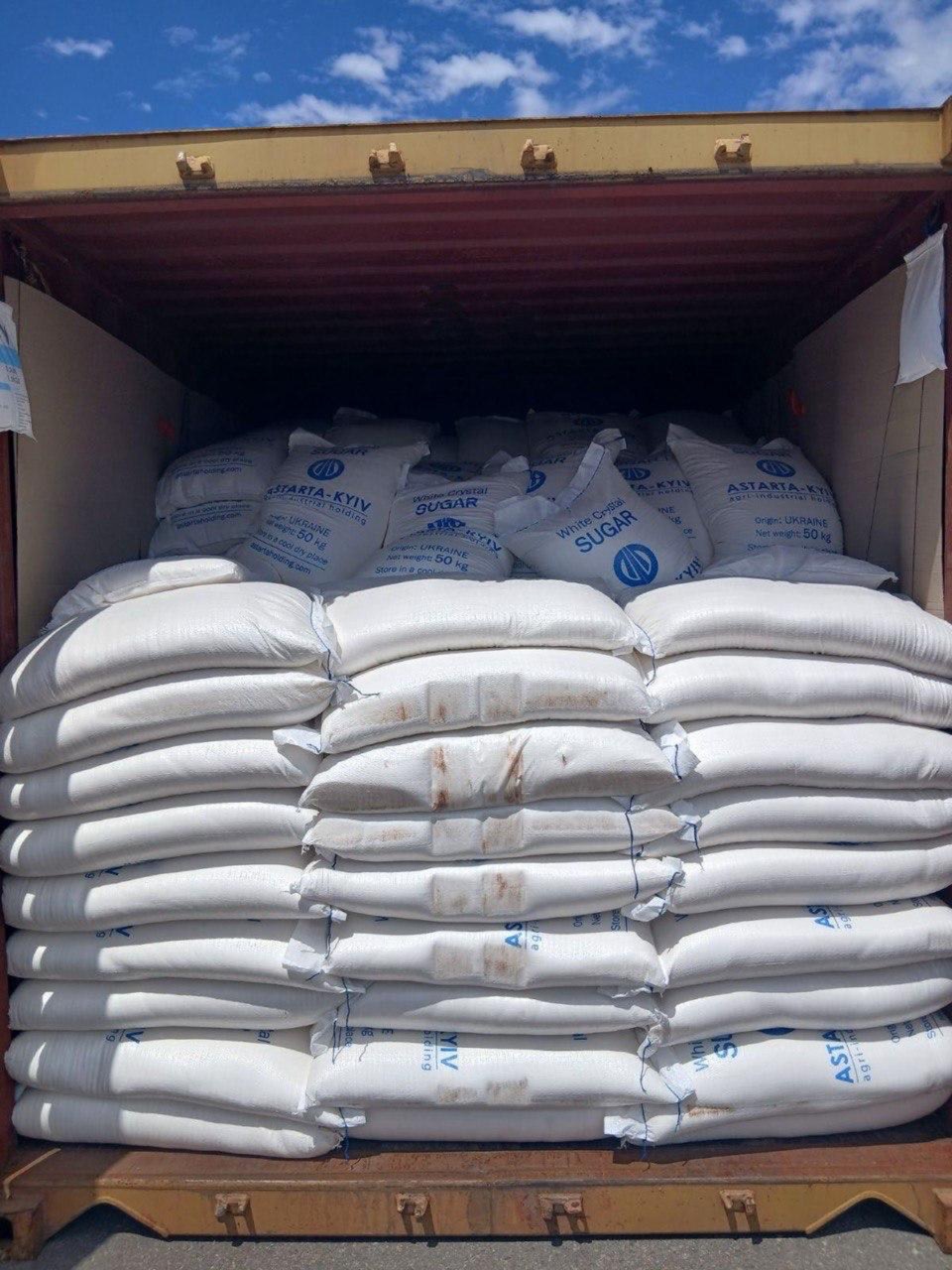 White sugar bags loaded into a shipping container